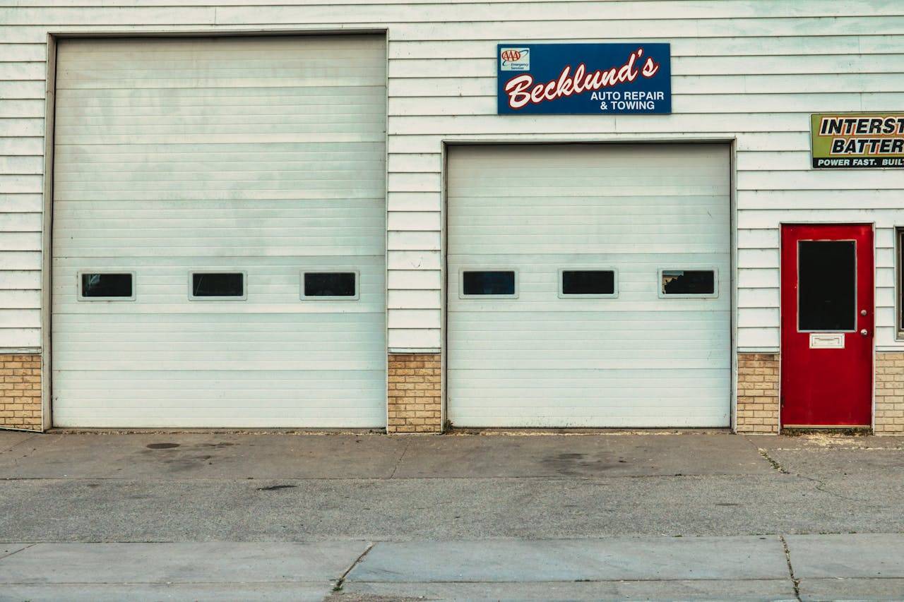 services-01 Front view of an auto repair shop with roll-up doors and signage in Millville, Minnesota.