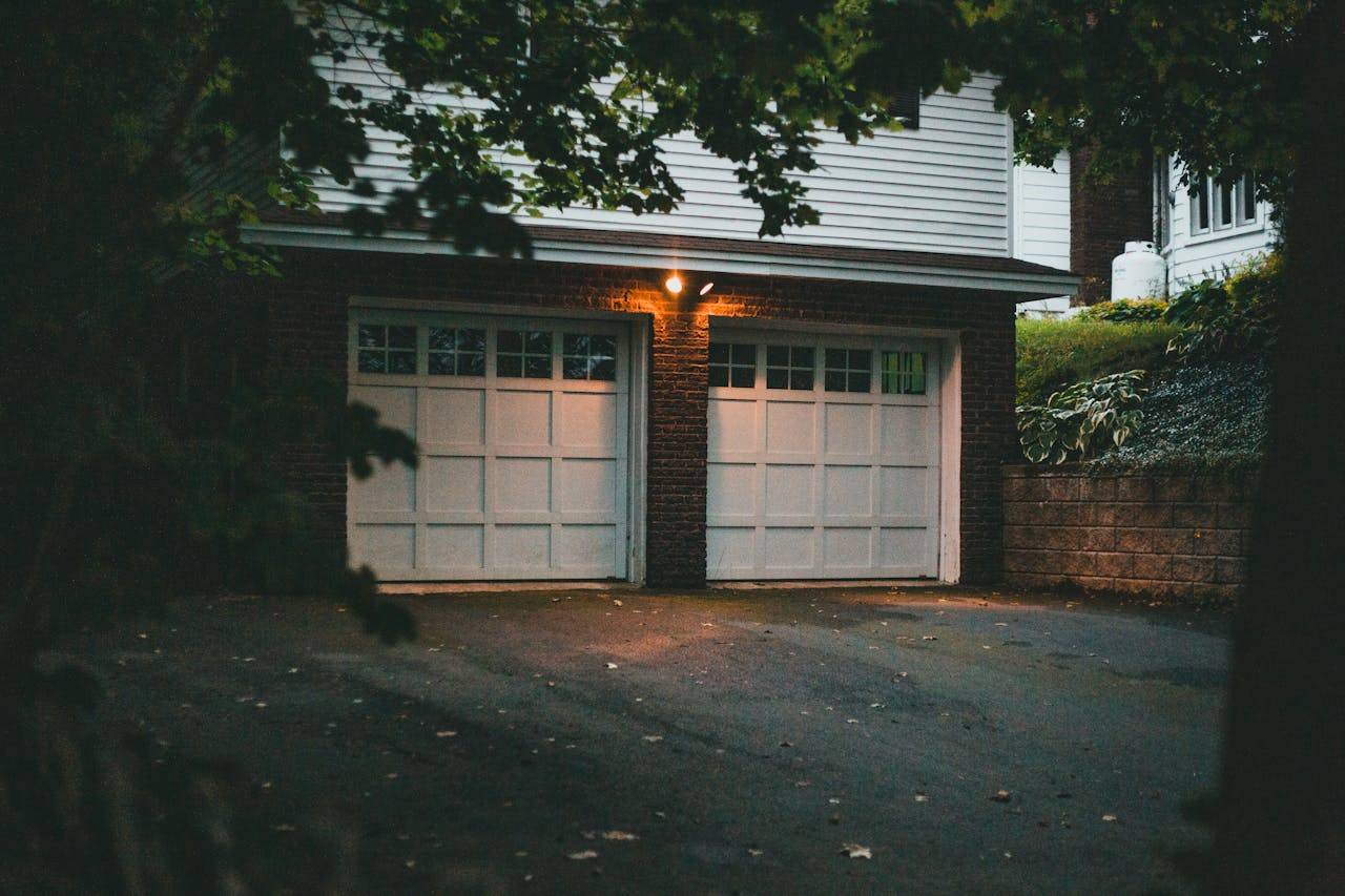 hero-img-02 Warm evening view of a suburban garage with soft lighting creating a cozy atmosphere.