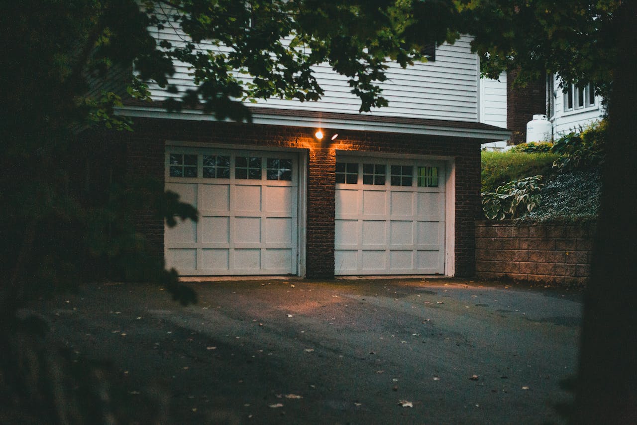 creative-03 Warm evening view of a suburban garage with soft lighting creating a cozy atmosphere.