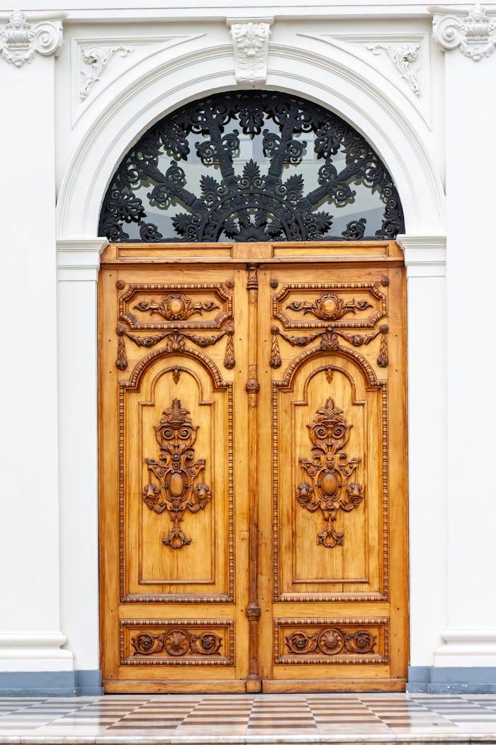 who-we-are Intricately designed wooden doors featuring detailed carvings and decorative ironwork.